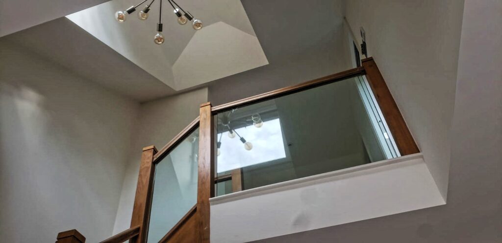 staircase with skylight leading to a spacy loft conversion